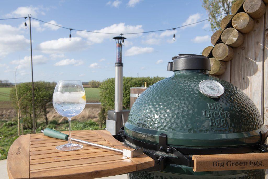 Steaks cooking on Big Green Egg barbecue at glamping pod Yorkshire