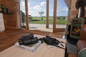 Binoculars on coffee table with field view in Truce Pod Scarborough North Yorkshire