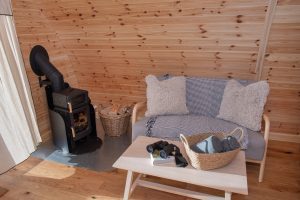 Shelter Pod interior stove and sofa, North Yorkshire glamping pod